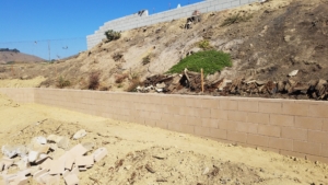 New concrete block retaining wall on hillside